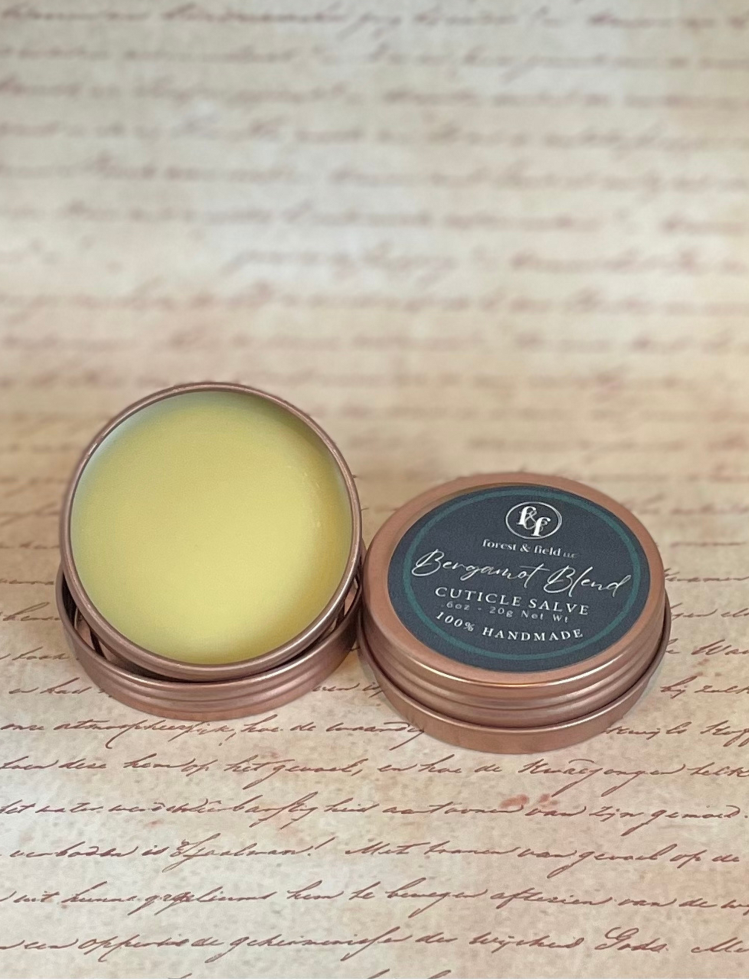 2oz rose gold tin filled with cuticle salve